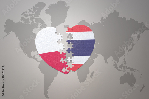 puzzle heart with the national flag of thailand and poland on a world map background.Concept.