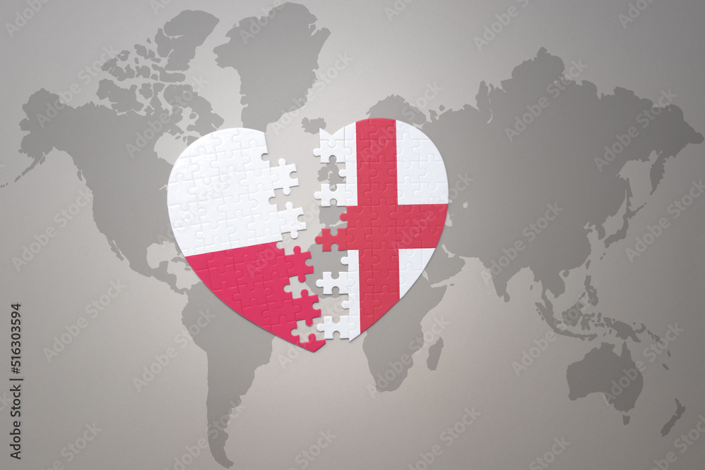 puzzle heart with the national flag of england and poland on a world map background.Concept. puzzle heart with the national flag of england and poland on a world map background.Concept.