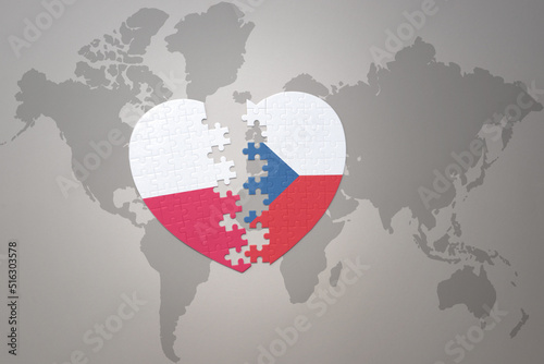 puzzle heart with the national flag of czech republic and poland on a world map background.Concept.