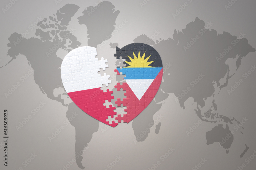 Obraz premium puzzle heart with the national flag of antigua and barbuda and poland on a world map background.Concept.