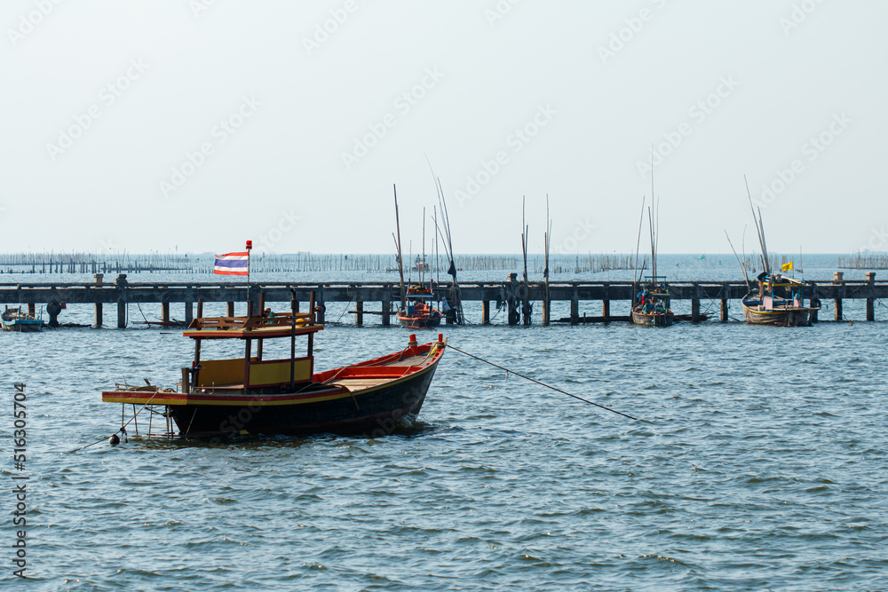 A fishing boat moored in the sea near a jetty