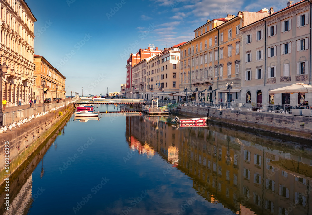 Attractive summer cityscape of Trieste, Italy, Europe. Wonderful morning view of Canal Grande di Trieste and street cafe. Traveling concept background.