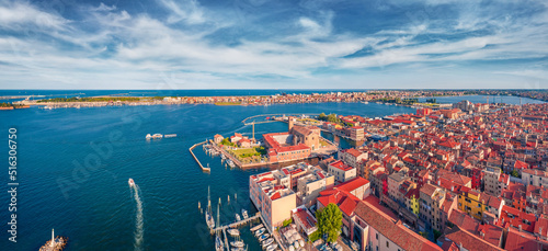 Red roof buildings in Sottomarina port. Magnificent morning seascape of Adriatic sea. Panoramic summser view of Italy, Euroipe. Traveling concept background. © Andrew Mayovskyy