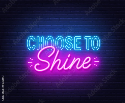 Choose to shine neon quote on brick wall background.