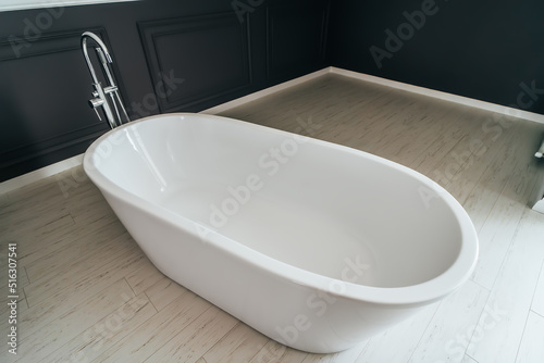 White bathroom in modern house stands in master bedroom.