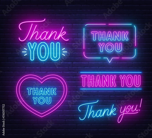 Thank You set neon sign on brick wall background.