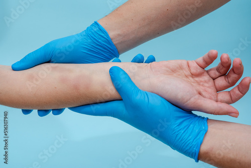 Doctor palpates and examines a large bruise on woman's arm isolated