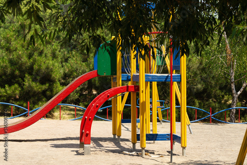playground on the sand of the sea beach among the trees photo