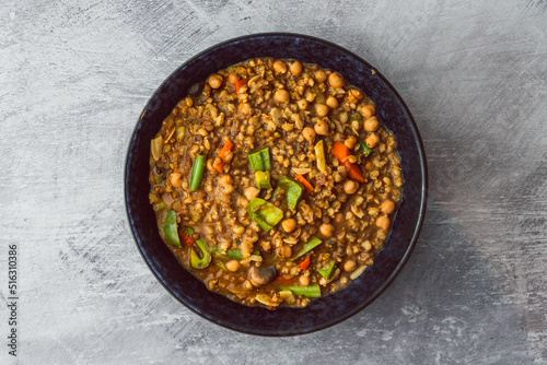 healthy plant-based food, vegan barley and lentil dahl with bell peppers,