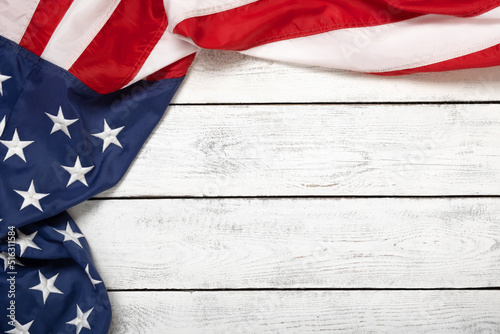 Flat lay USA flag on white wooden board, vintage background with copy space top view. Banner, minimalism. American