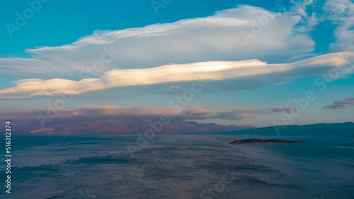 Lenticular clouds over the sea and mountains, Agios Nikolaos, Crete, Greece, day to night, time lapse.