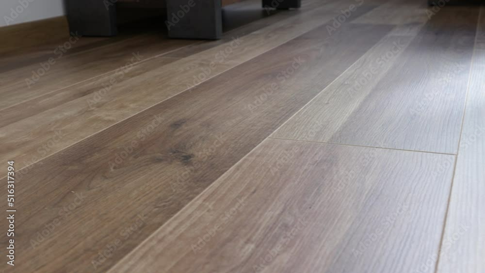 New laminate flooring. Laminated parquet with brown wooden texture