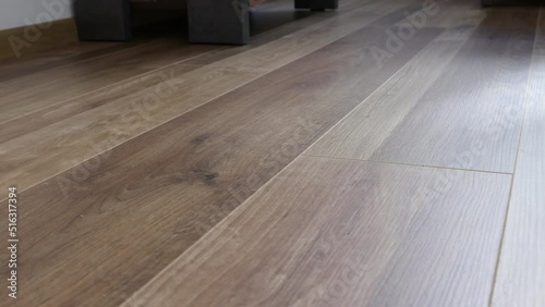 New laminate flooring. Laminated parquet with brown wooden texture