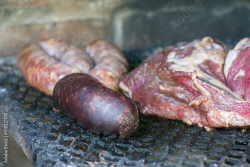 Typical blood sausage surrounded by a delicious cuts of Argentine meat cut and pork sausages. Selective focus