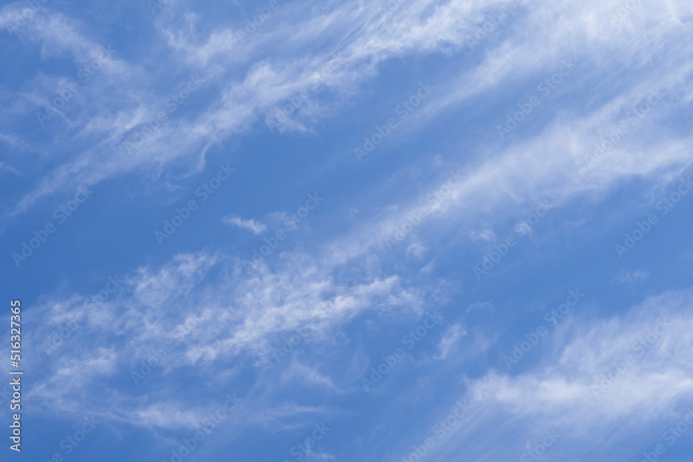 Abstract delicate blue-white background. Bright beautiful blue sky with soft clouds for background or texture. Blue sky and clouds. Natural background