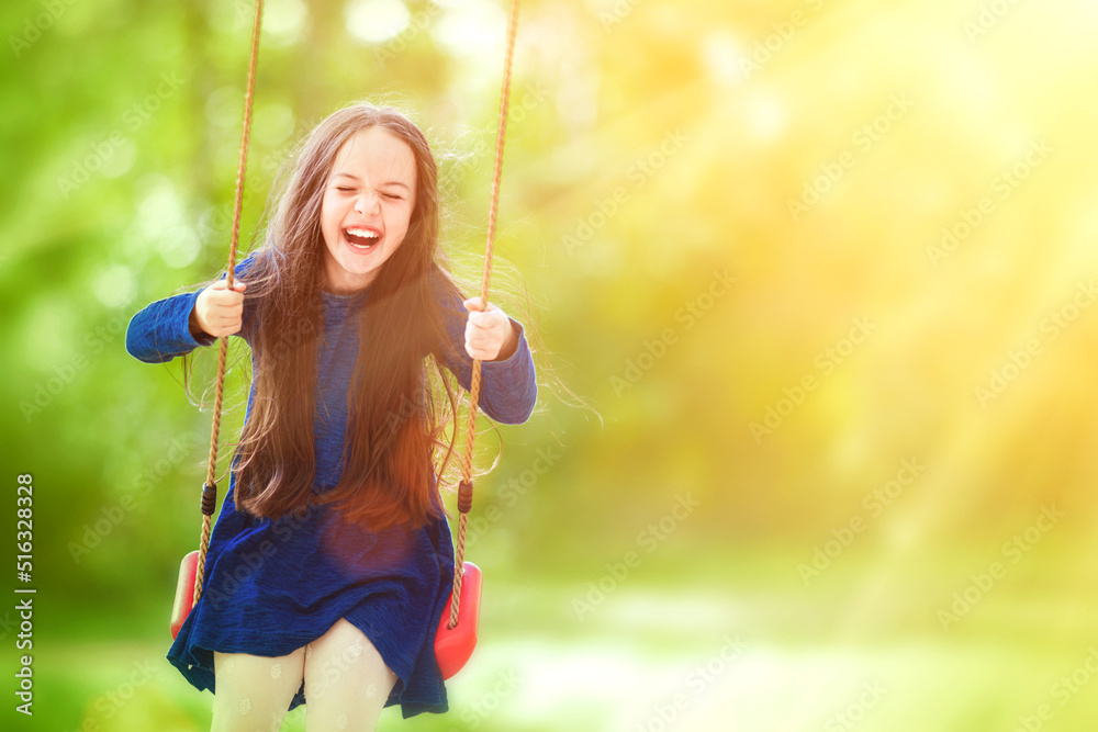 Cute little girl on a swing in the park. Fun, joy, freedom. Stock Photo ...