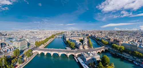Paris aerial panorama with river Seine, Pont Neuf bridge, ile de la cite and Notre-Dame church, France. Holidays vacation destination. Panoramic view above historical Parisian buildings and landmarks. © NicoElNino