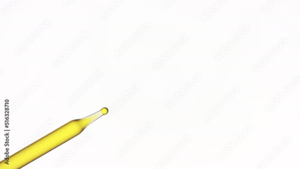 Macro shot of palm oil is dripping from chemical dropper on white background | Abstract body care cosmetics with palm oil formulation concept Macro shot of palm oil is dripping from chemical dropper on white background | Abstract body care cosmetics with palm oil formulation concept