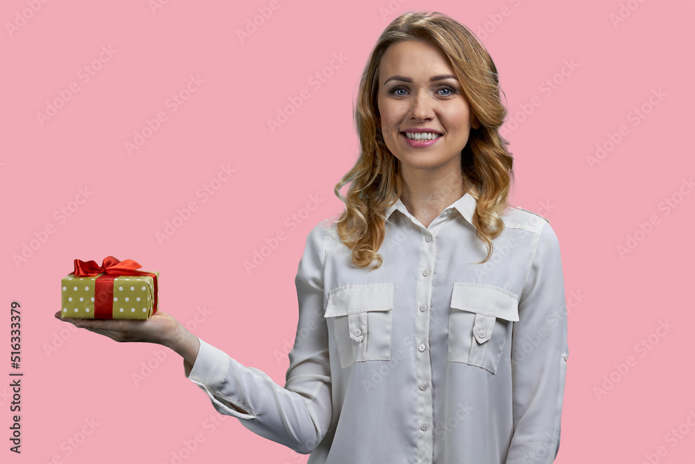Portrait of beautiful smiling woman holding gift box in her hand. Attractive girl posing with present box on color background. Portrait of beautiful smiling woman holding gift box in her hand. Attractive girl posing with present box on color background.