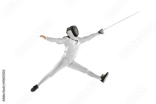 Dynamic portrait of female fencer in sports costume with rapier in hand training isolated on white background. Sport, youth, healthy lifestyle, achievements.