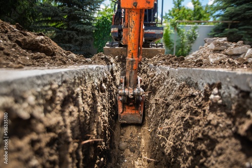 Driver working on an tractor or earthmoving machine photo