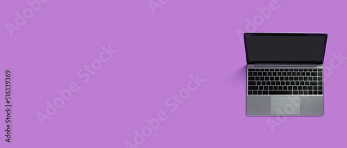 Top view of modern laptop isolated on colored background. Copy space photo