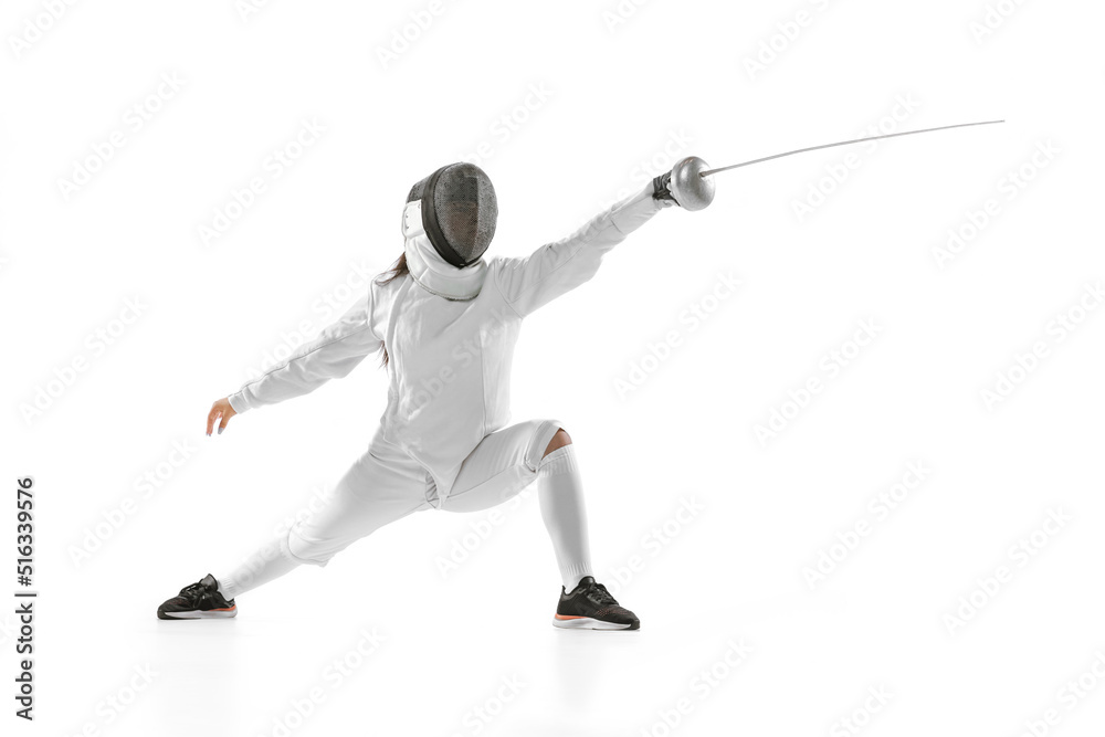 Young girl, beginner fencer in fencing costume and mask practicing with rapier isolated on white background. Sport, youth, healthy lifestyle, achievements. Young girl, beginner fencer in fencing costume and mask practicing with rapier isolated on white background. Sport, youth, healthy lifestyle, achievements.