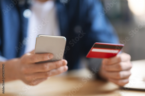 E-Commerce Concept. Closeup Shot Of Unrecognizable Male Using Smartphone And Credit Card