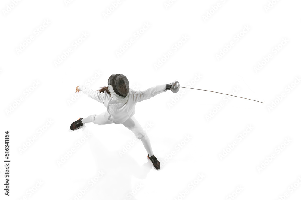 Young girl, beginner fencer in fencing costume and mask practicing with rapier isolated on white background. Sport, youth, healthy lifestyle, achievements. Young girl, beginner fencer in fencing costume and mask practicing with rapier isolated on white background. Sport, youth, healthy lifestyle, achievements.