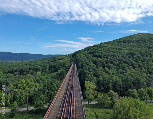 Fototapete Aerial view of a train bridge in the mountains