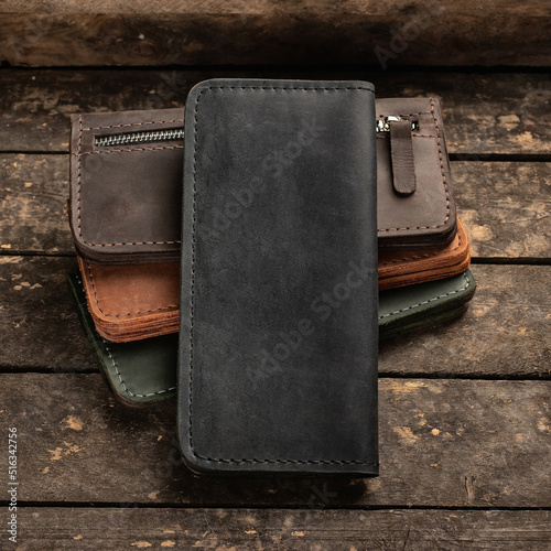 Set of stylish leather wallets on a vintage wooden background. Copy space © serkucher