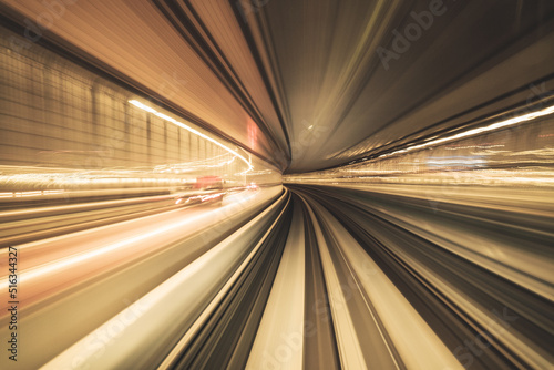 Motion blurred of train moving inside tunnel with daylight in tokyo, Japan. yollow color background concept