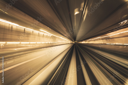 Motion blurred of train moving inside tunnel with daylight in tokyo, Japan. yollow color background concept