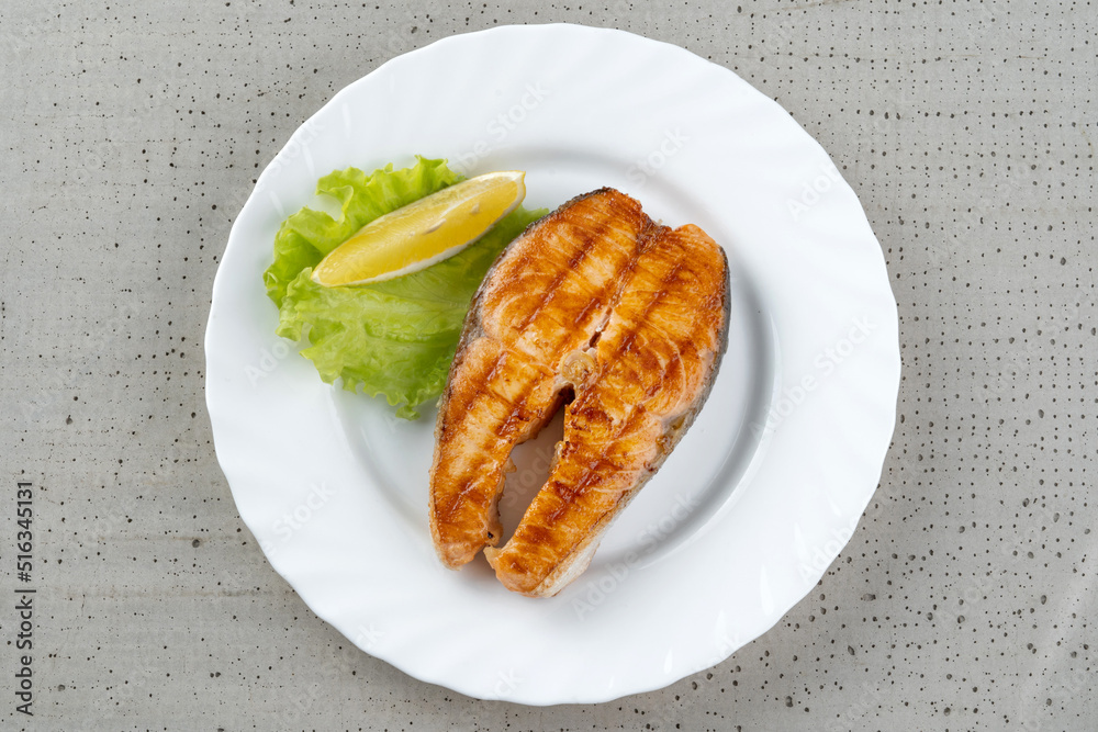 Salmon teriyaki steak with lemon and lettuce. Salmon teriyaki steak with lemon and lettuce.