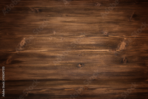 Dark wood texture background. Wooden surface with nature pattern. Top view of a vintage wooden plank. Brown matte rustic wood for a background photo