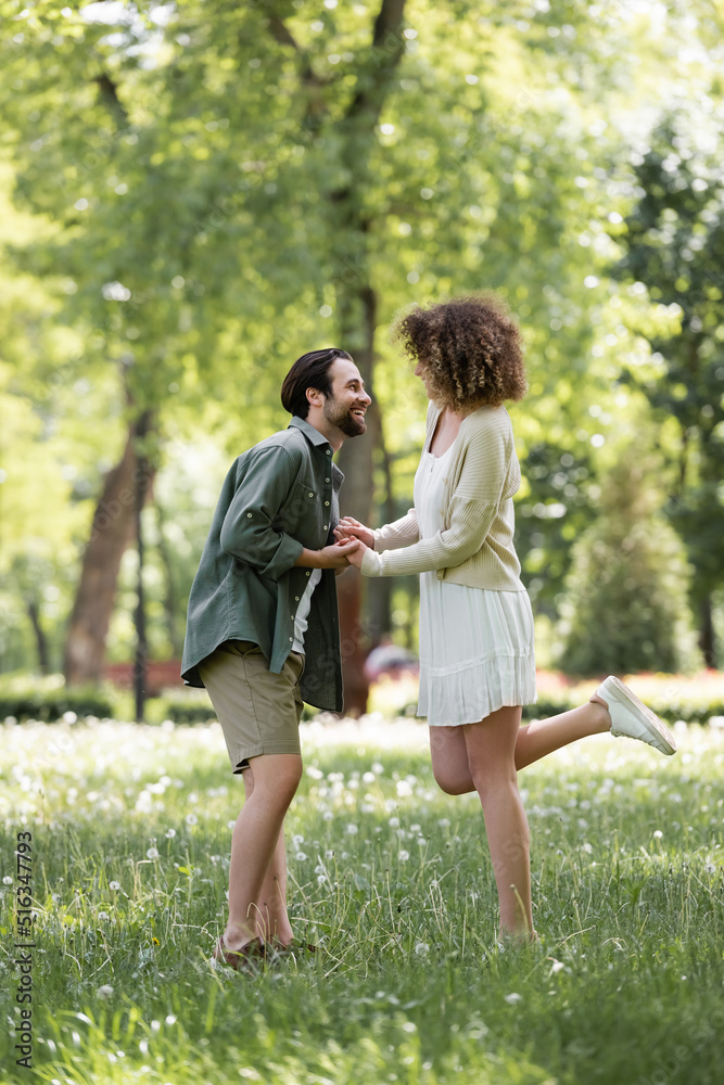 full length of happy young couple having date in green park. full length of happy young couple having date in green park.