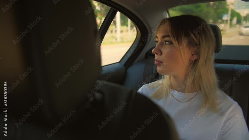 Sad Young Woman riding in Car on Backseat of taxi car. Slow Motion.Sad face young girl.Driving car in city.Close-Up Sad Young Woman riding in Car on Backseat of taxi car. Slow Motion.Sad face young girl.Driving car in city.Close-Up