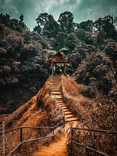 Canvas Print Stairs leading to the observation deck of Tad Yuang Waterfall, at sunset under g