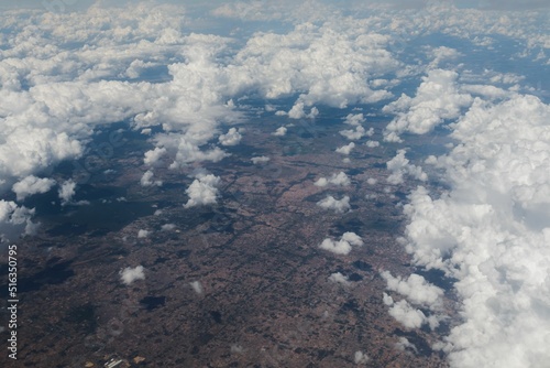 Cuadro en lienzo Aerial view of landscapes through fluffy white clouds