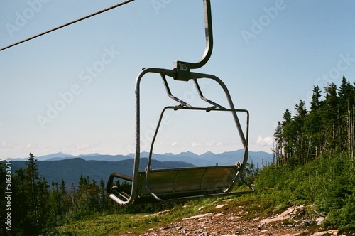 Chairlift in the Whiteface mountain with green trees photo