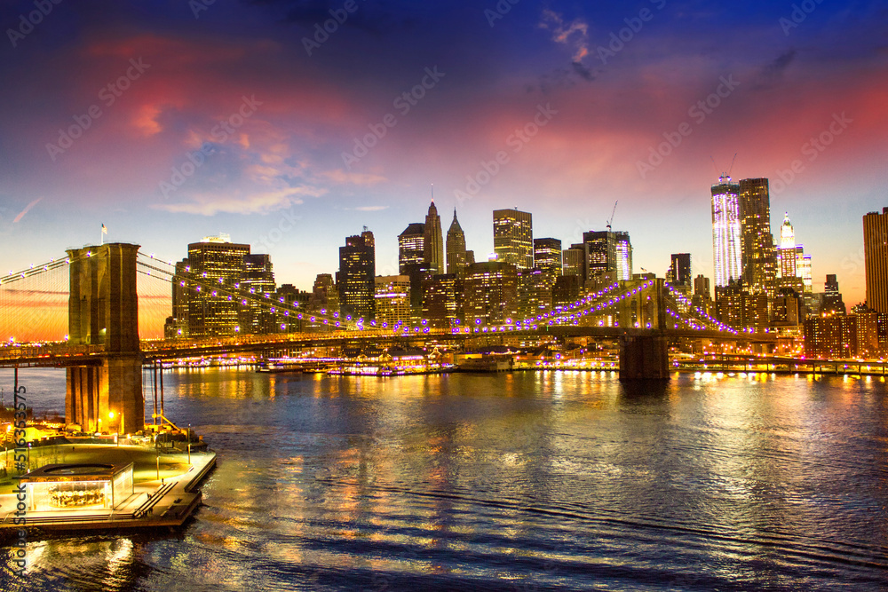 Brooklyn Bridge and Manhattan at sunset on East River, New York