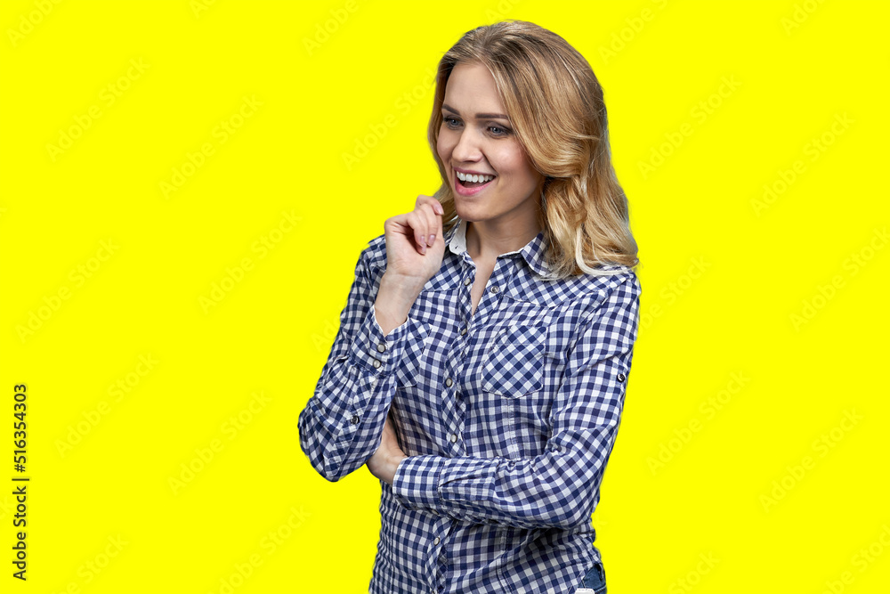 Pretty pensive girl with sly and cunning smile standing on color background. Woman having an interesting plan. Pretty pensive girl with sly and cunning smile standing on color background. Woman having an interesting plan.