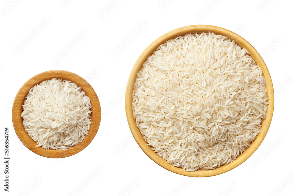 Raw long rice basmati in a wooden bowl isolated on white background top view. Raw long rice basmati in a wooden bowl isolated on white background top view.