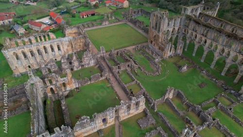 Tourists On Historical Ruins Of Rievaulx Abbey Near Helmsley In The North York Moors National Park, North Yorkshire, England. Aerial Drone Shot photo