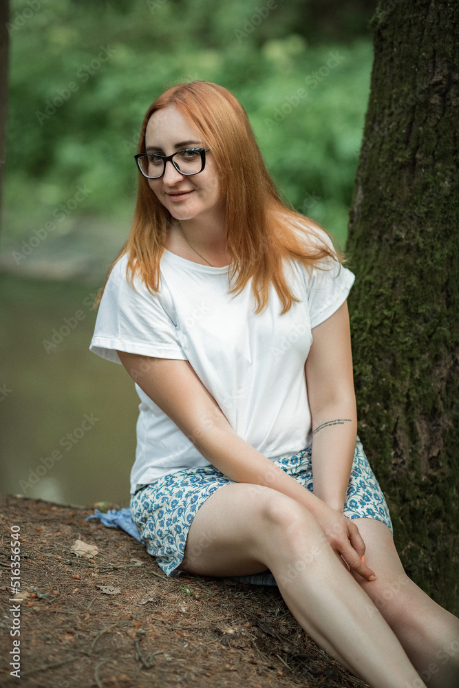 Portrait of a young beautiful girl in glasses in the forest. Portrait of a young beautiful girl in glasses in the forest.