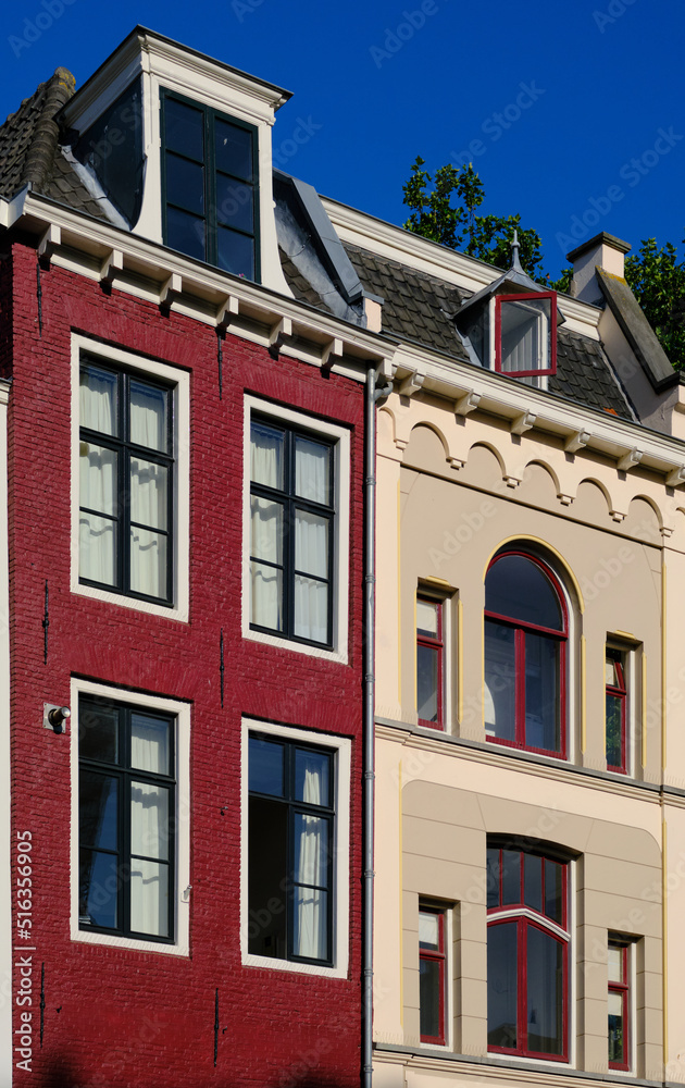 Naklejka premium Utrecht, The Netherlands - July 7, 2022. Traditional old houses on the Oudegracht (Old Canal) in city centre. Summertime with clear blue sky.
