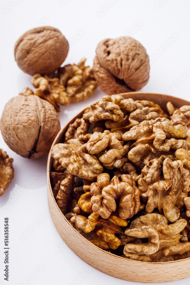dried walnuts on a white acrylic background dried walnuts on a white acrylic background