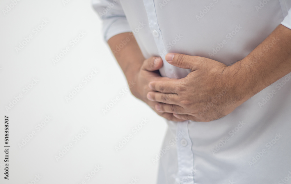 Man's hand holding his stomach touch the pain area