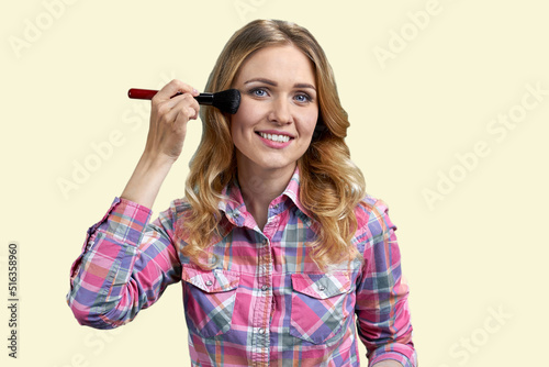 Wallpaper Mural Young beautiful woman using makeup brush on white background. Natural beauty concept. Torontodigital.ca