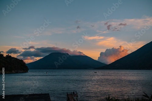 Beautiful shot of the Lake Atitlan in the background of mountains in the sunset. photo